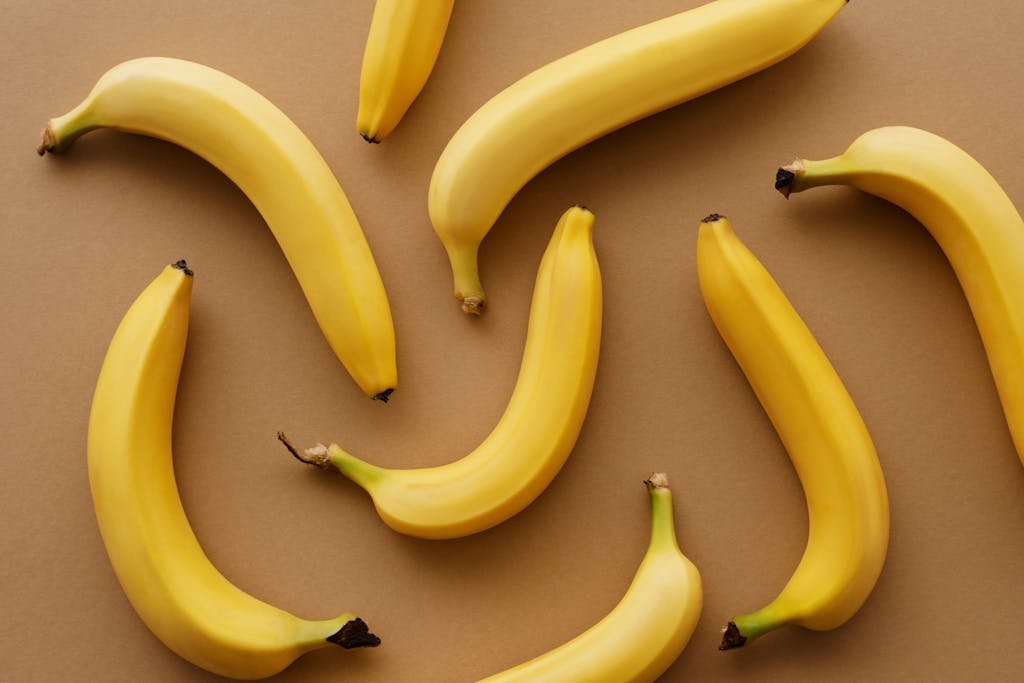 Top view of ripe bananas arranged on a brown background, perfect for healthy eating concepts.