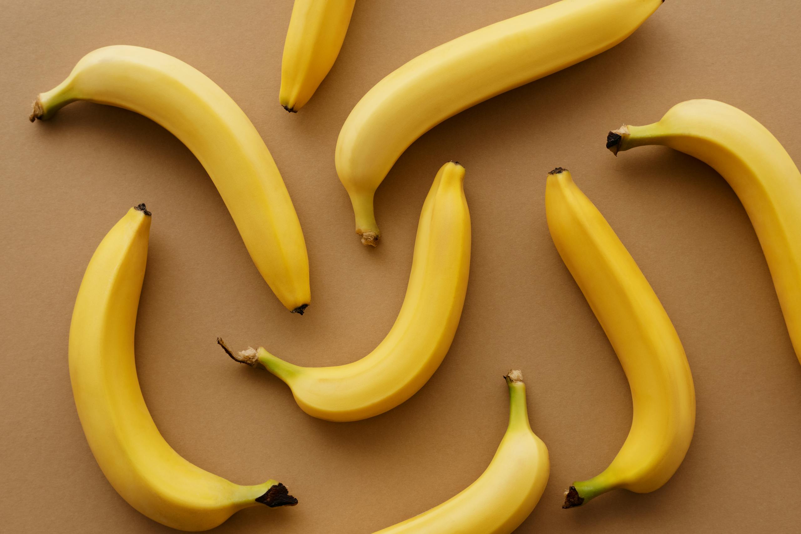 Top view of ripe bananas arranged on a brown background, perfect for healthy eating concepts.